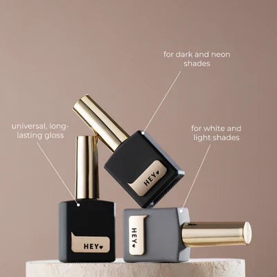 Three Hey gel nail polish bottles for dark, neon, white, and light manicure shades