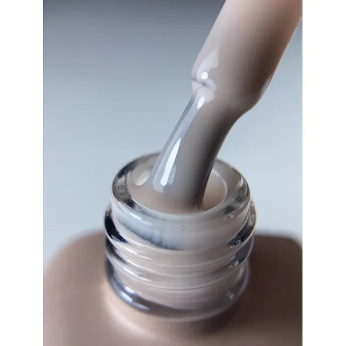 Close-up of a brush with nude UV gel polish, ideal for manicures and nail art.