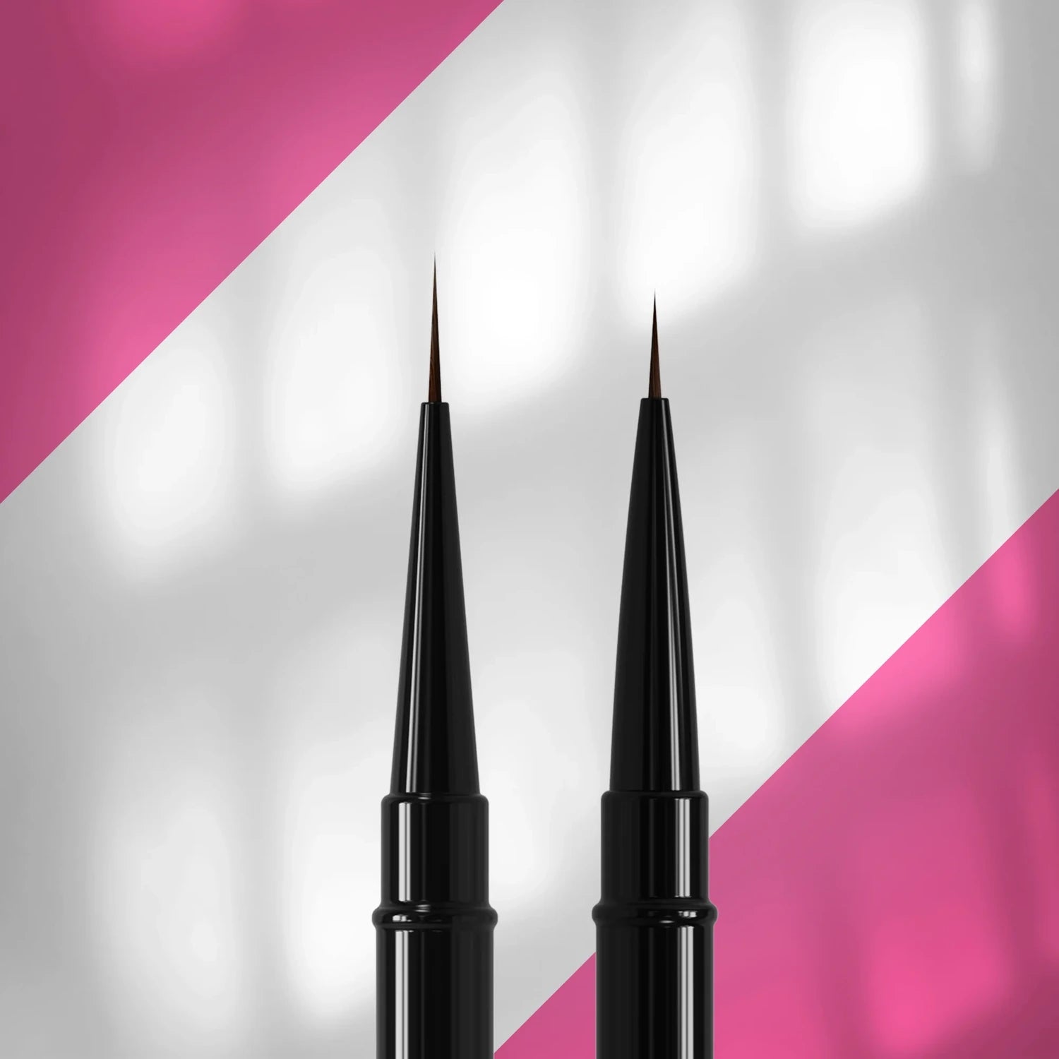 Two fine nail art brushes with black handles on a pink and white background