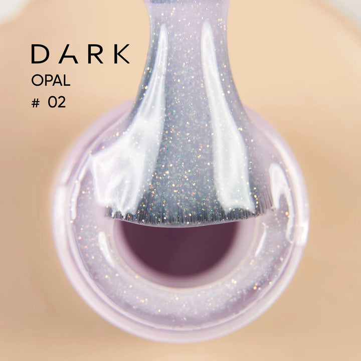 Close-up of glittery purple nail polish brush above open bottle, labeled Dark Opal 