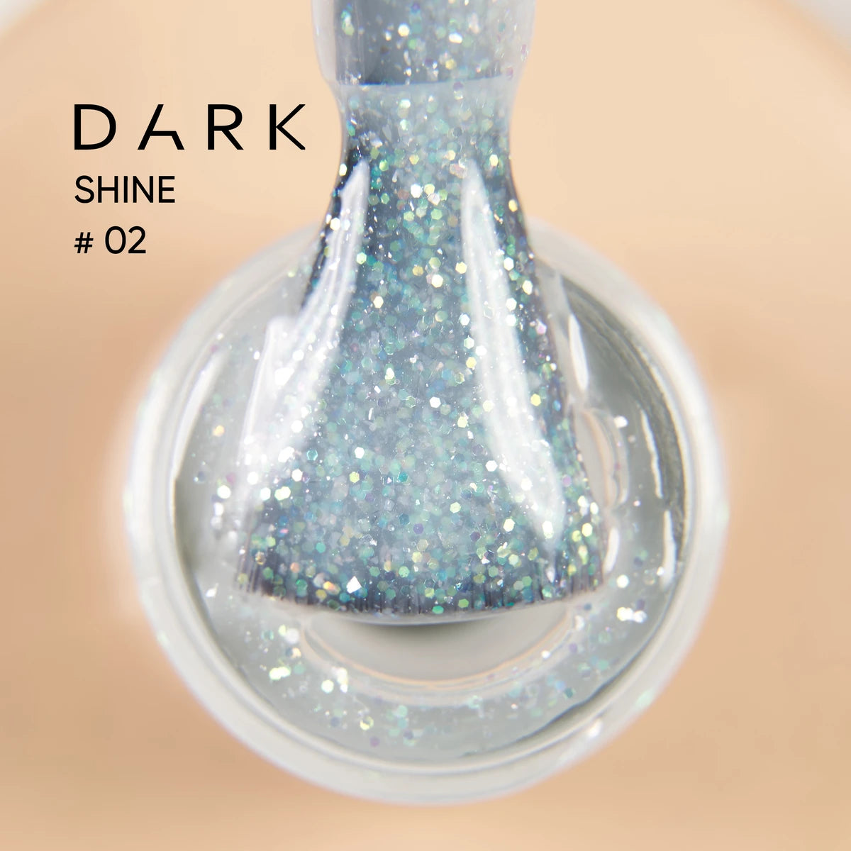 Close-up of glittery UV gel nail polish brush, labeled Dark Shine #02, in clear bottle