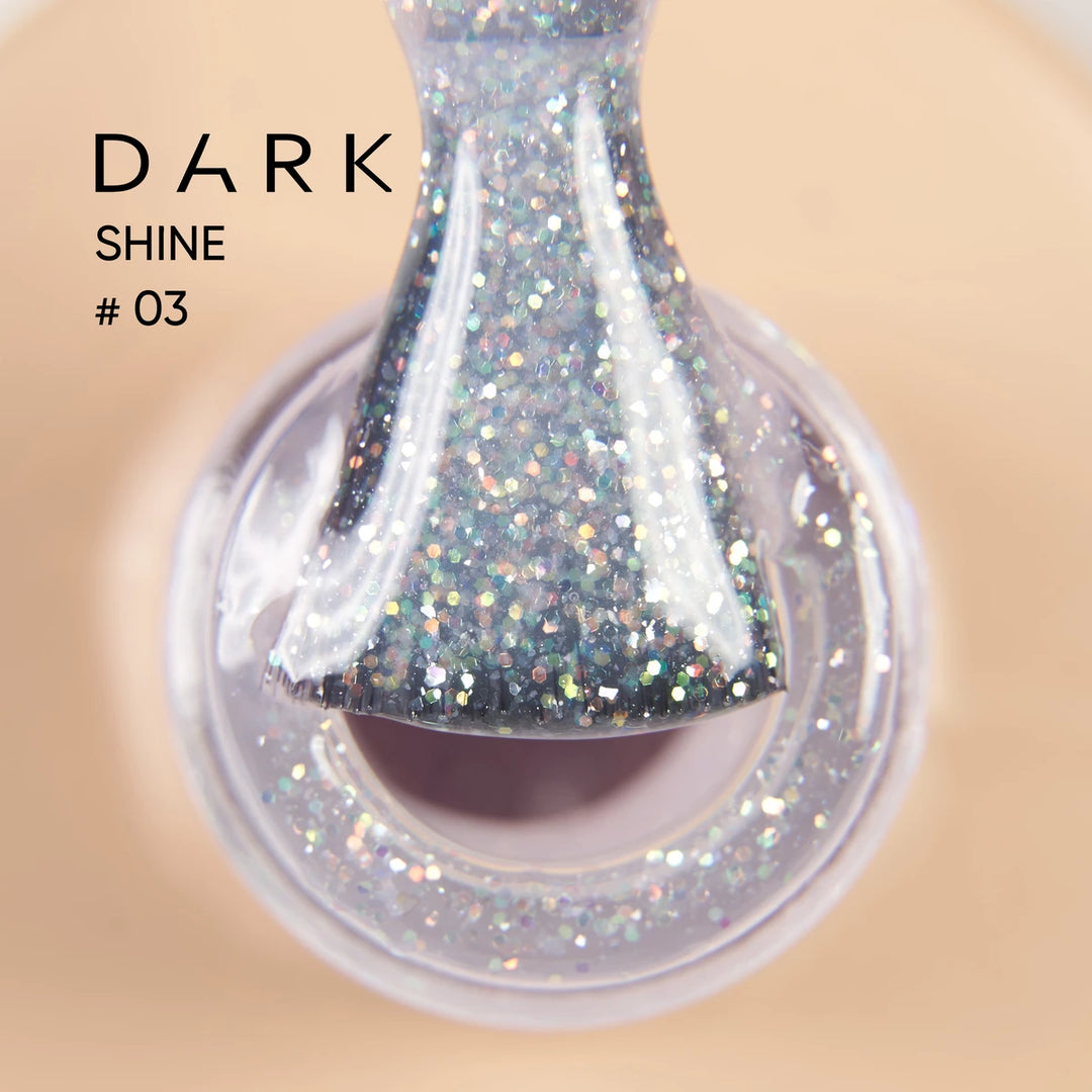 Close-up of glittery gel nail polish brush labeled Dark Shine 