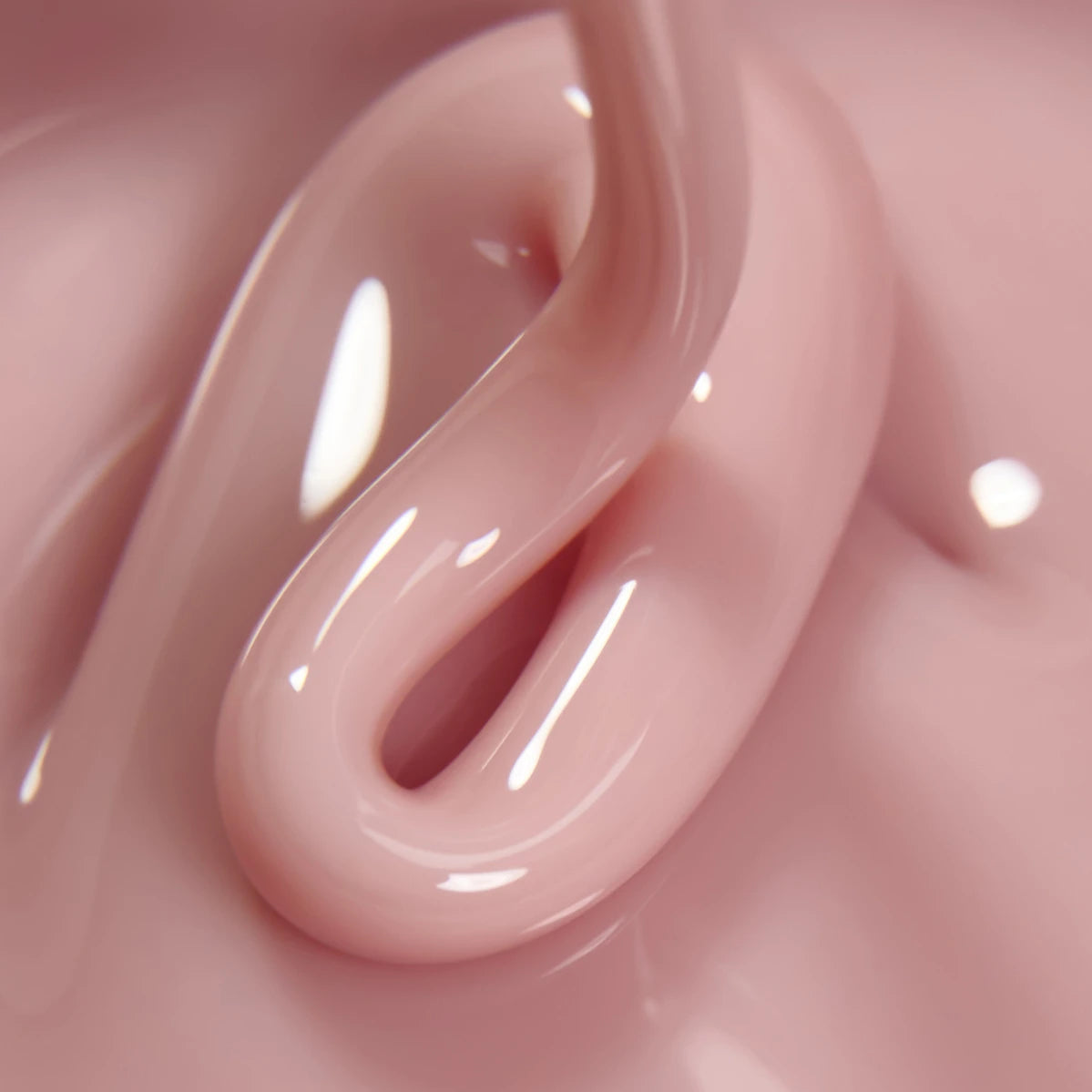 Close-up of pink UV nail gel with glossy, smooth texture for manicure applications.