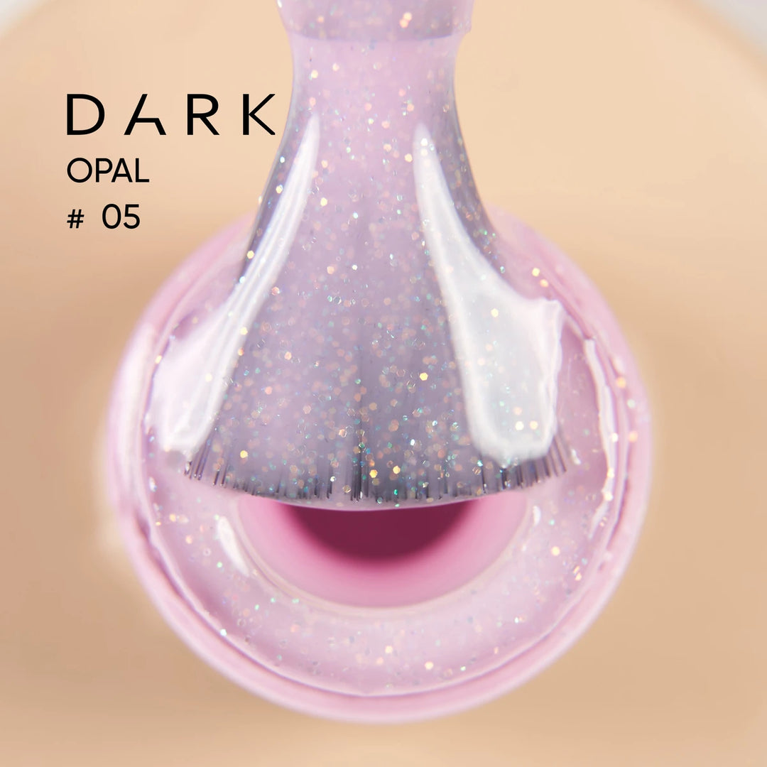 Pink opal glitter gel polish on brush, close-up, labeled Dark Opal 