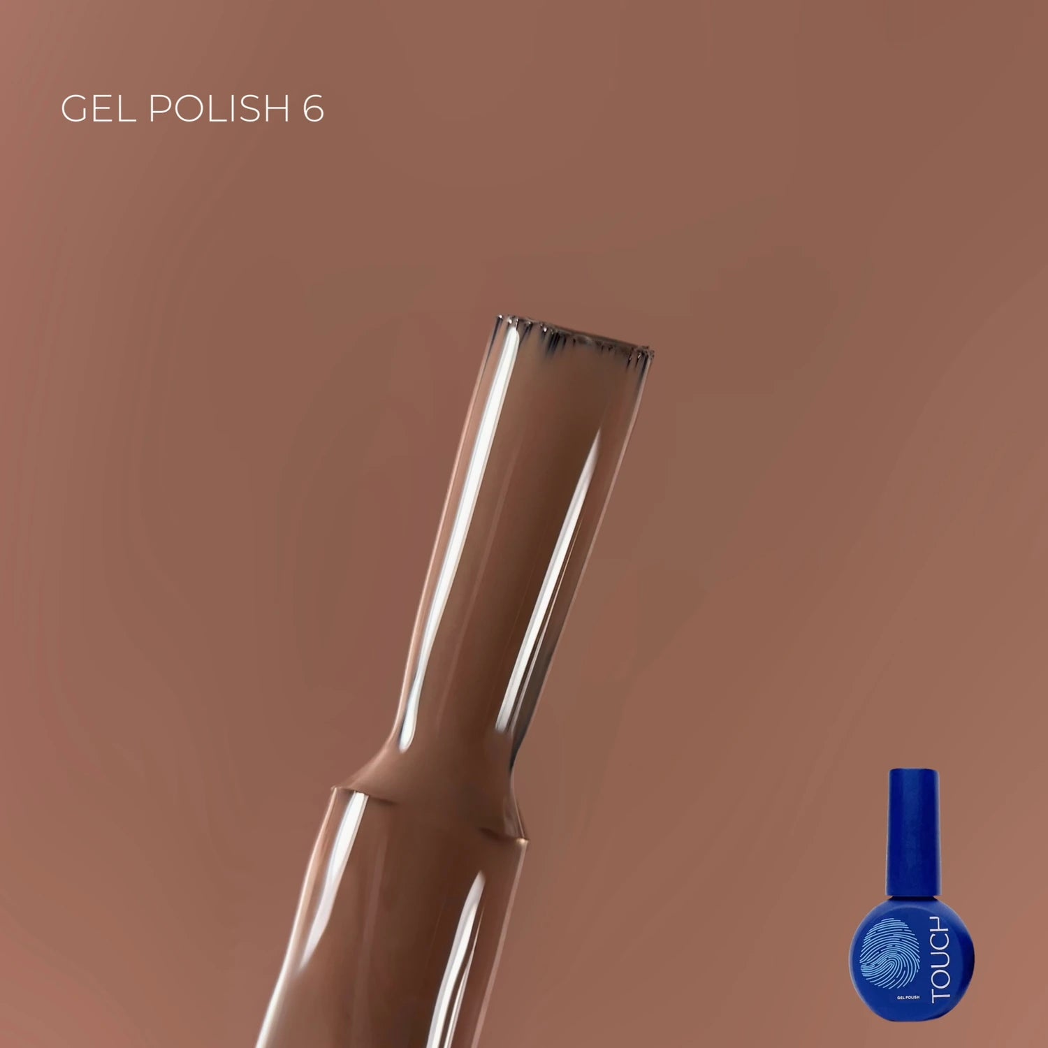 Brown gel nail polish brush close-up with blue polish bottle on brown background