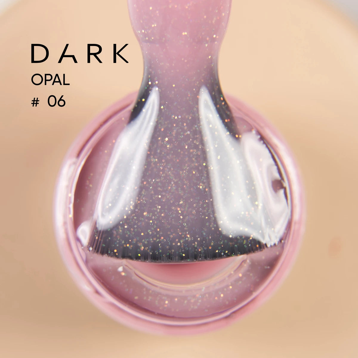 Glittery pink dark opal gel polish on brush, close-up manicure product shot