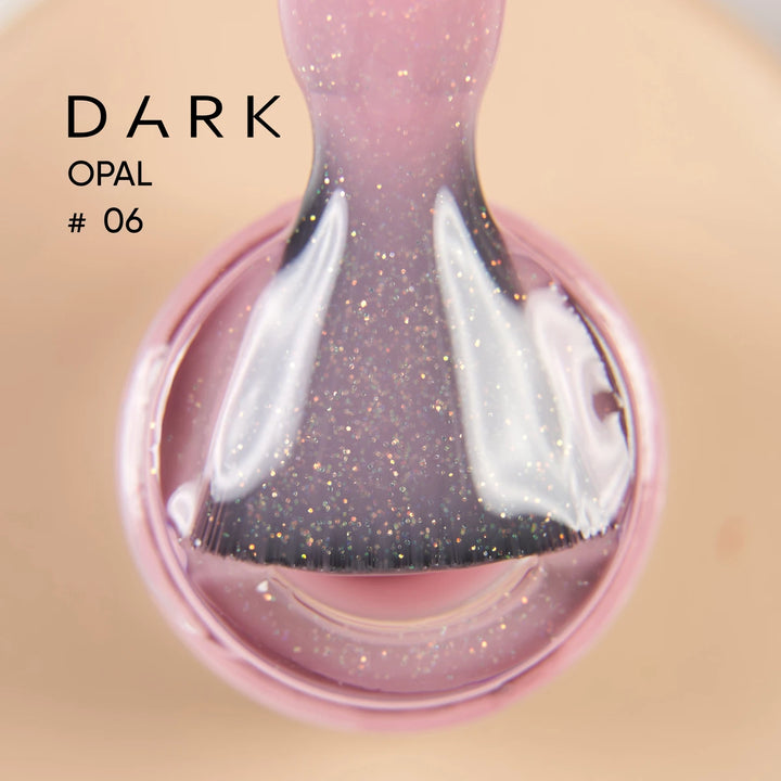 Glittery pink dark opal gel polish on brush, close-up manicure product shot