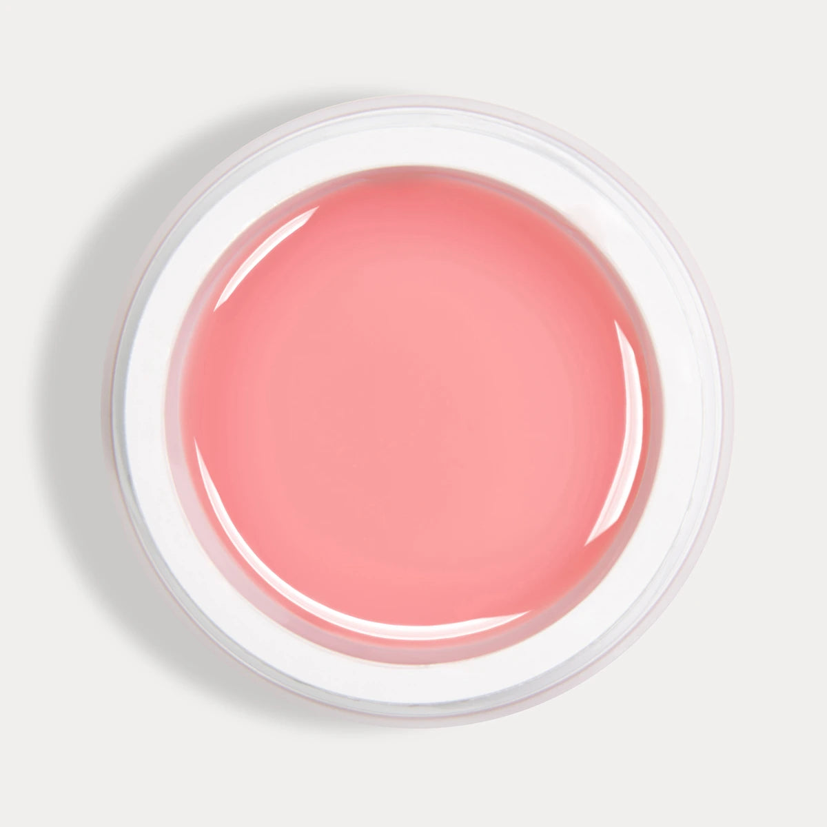 Open jar of pink UV nail builder gel for manicure on white background