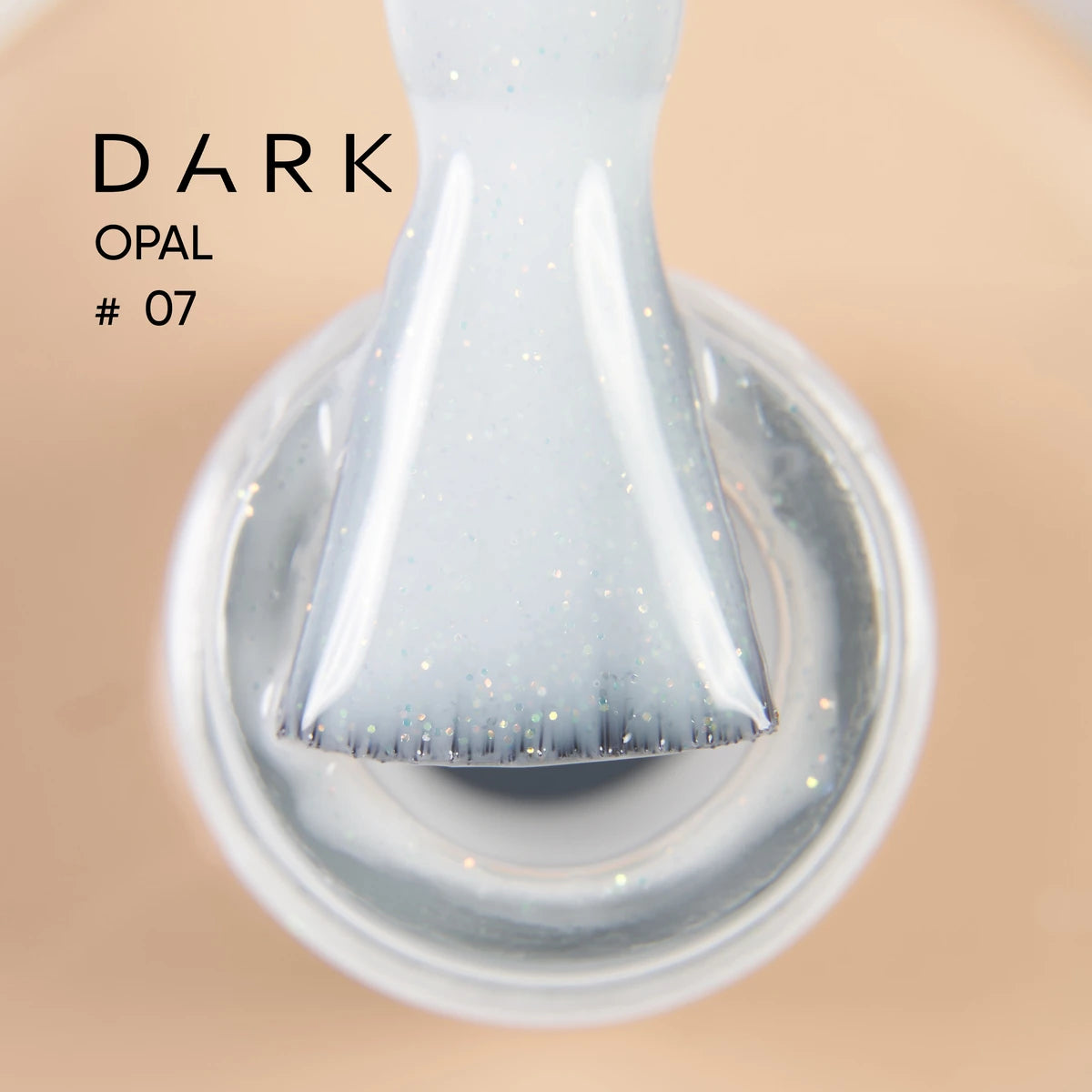 Close-up of brush with shimmery light opal gel polish, labeled Dark Opal #07.