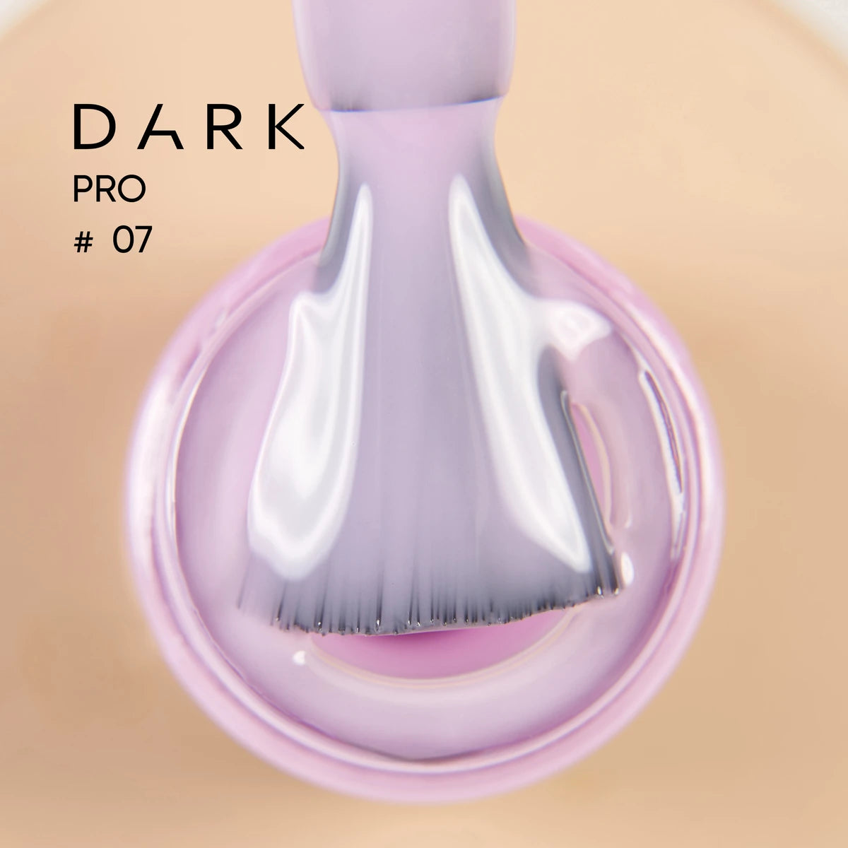 Close-up of a brush dipped in glossy light purple gel nail polish, labeled Dark Pro #07.