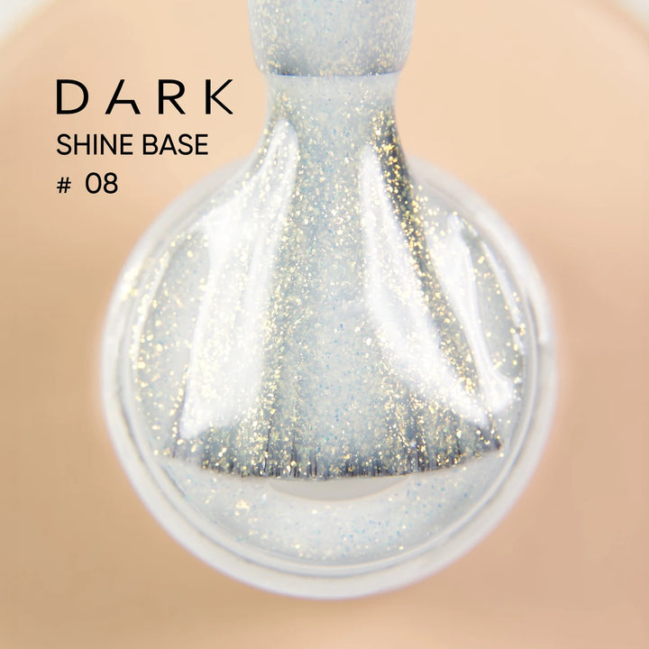 Close-up of brush applying sparkly pale blue gel polish, labeled Dark Shine Base 