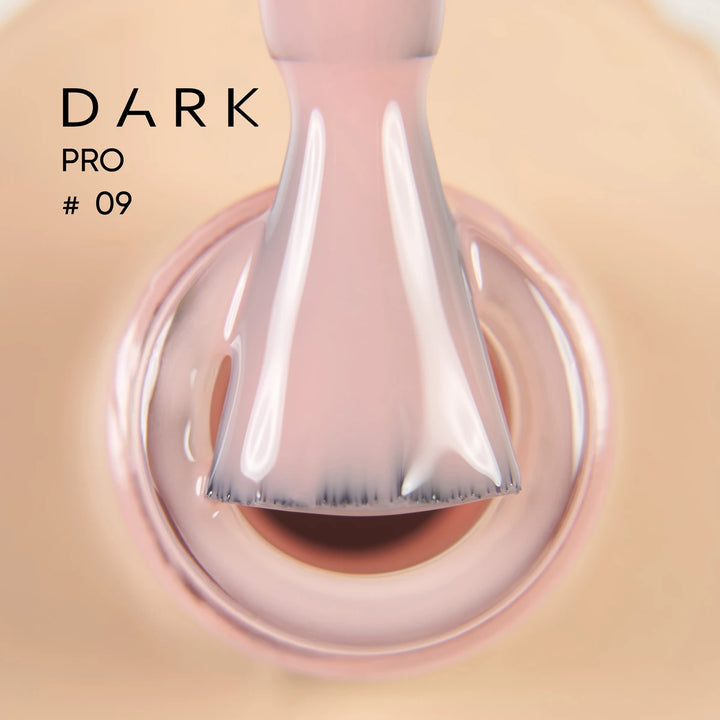 Close-up of nude pink gel nail polish brush and bottle, professional manicure product.