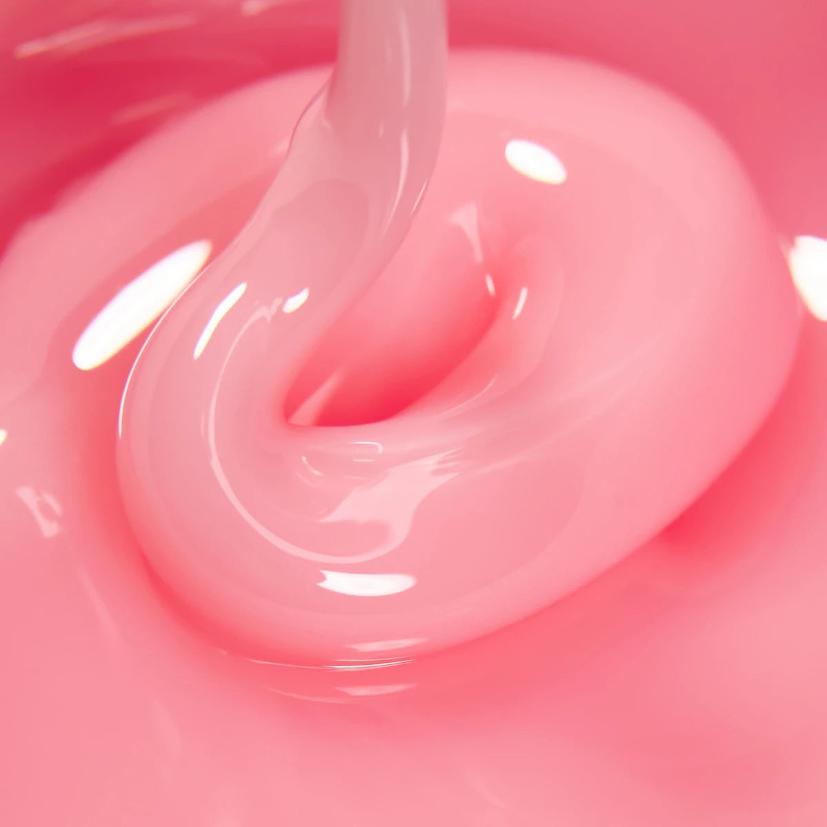 Close-up of pink UV gel nail polish with glossy texture for manicure