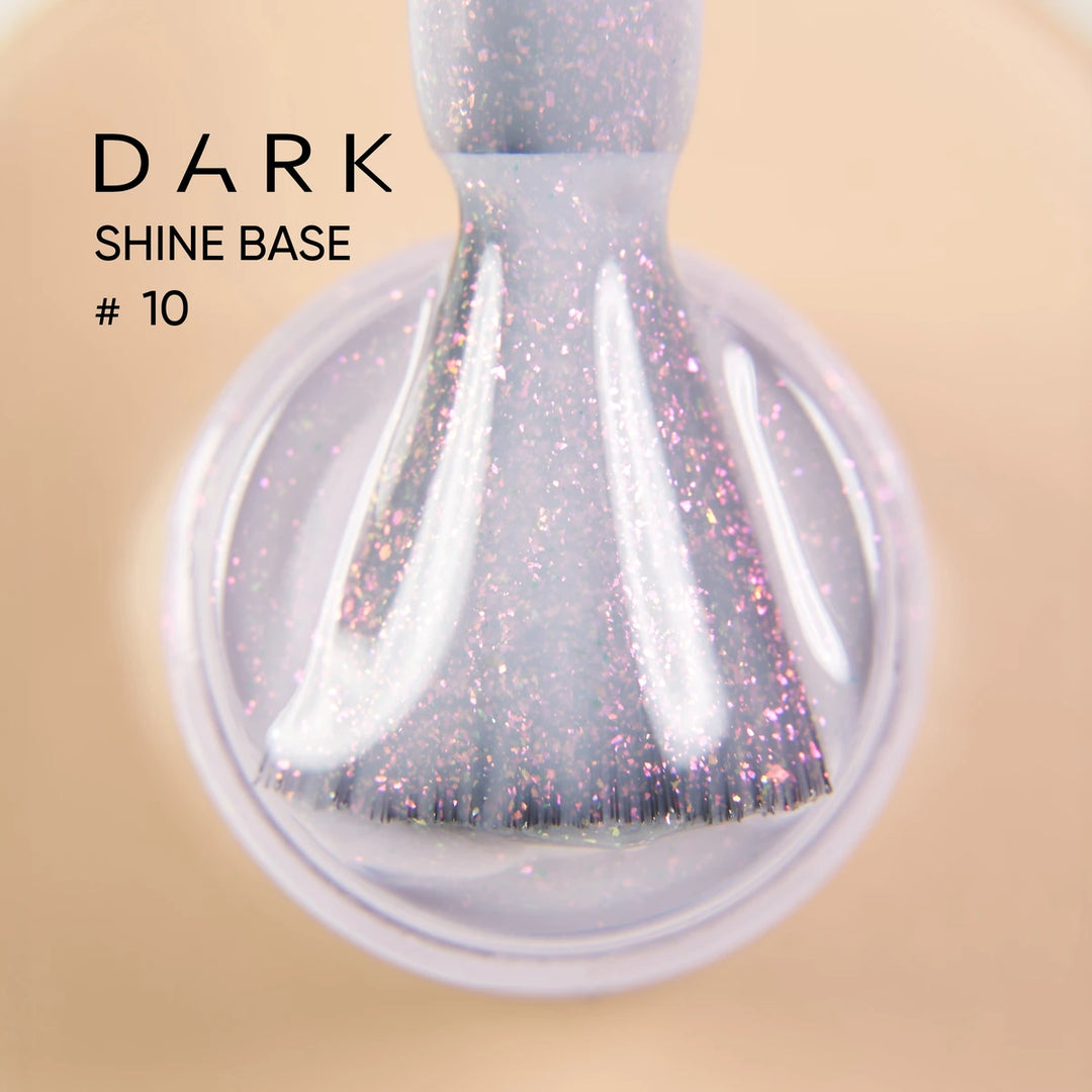 Close-up of a nail polish brush with sparkling purple gel, labeled Dark Shine Base 