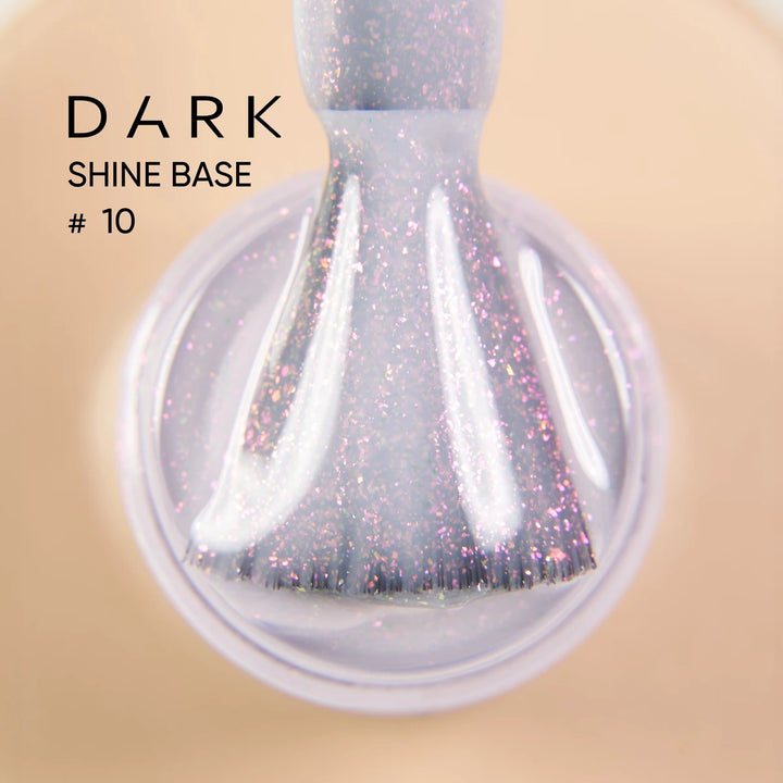 Close-up of a nail polish brush with sparkling purple gel, labeled Dark Shine Base 
