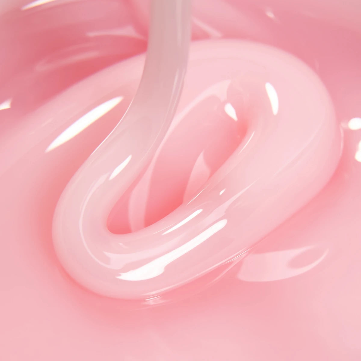 Close-up of pink UV gel for nails with glossy, smooth texture, ideal for manicures.
