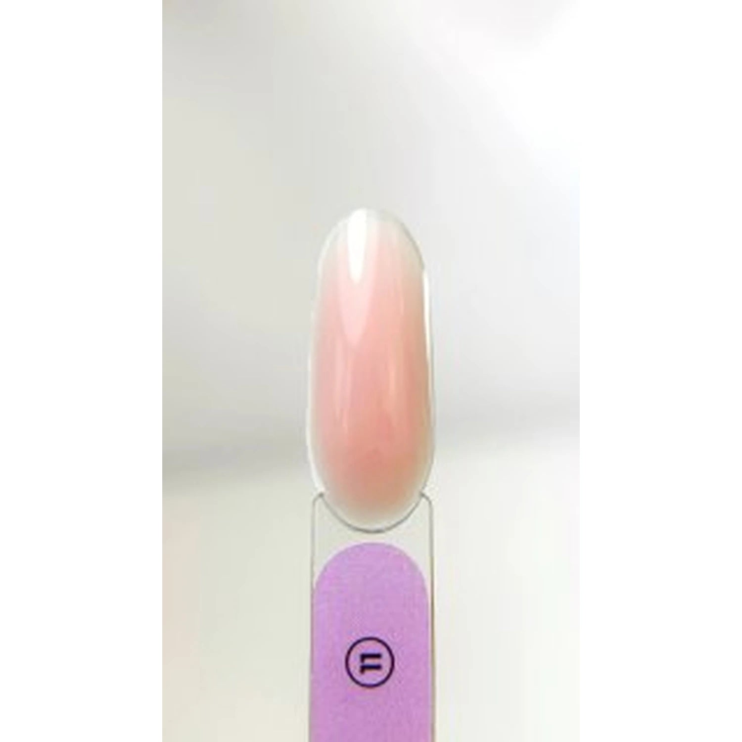 Sample nail tip with glossy light pink UV gel polish on a display stick