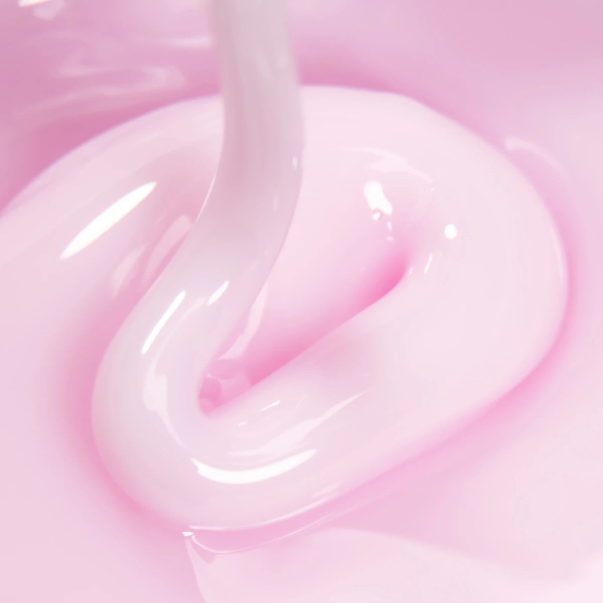Close-up of light pink UV gel polish with glossy texture for nail art and manicure