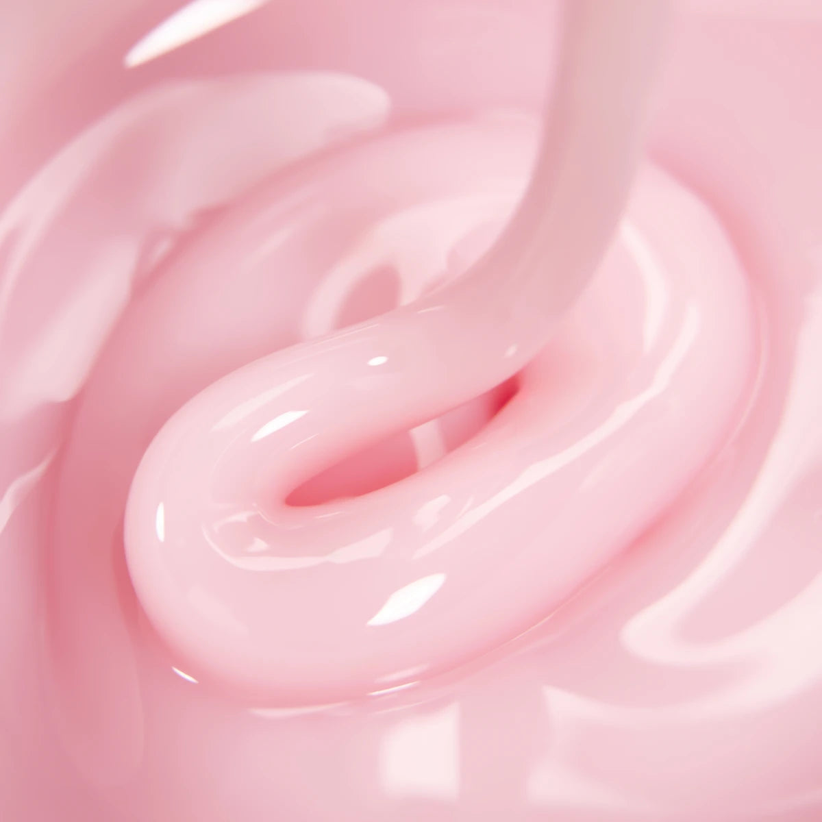 Close-up of light pink UV gel for nails with creamy texture, suitable for manicures
