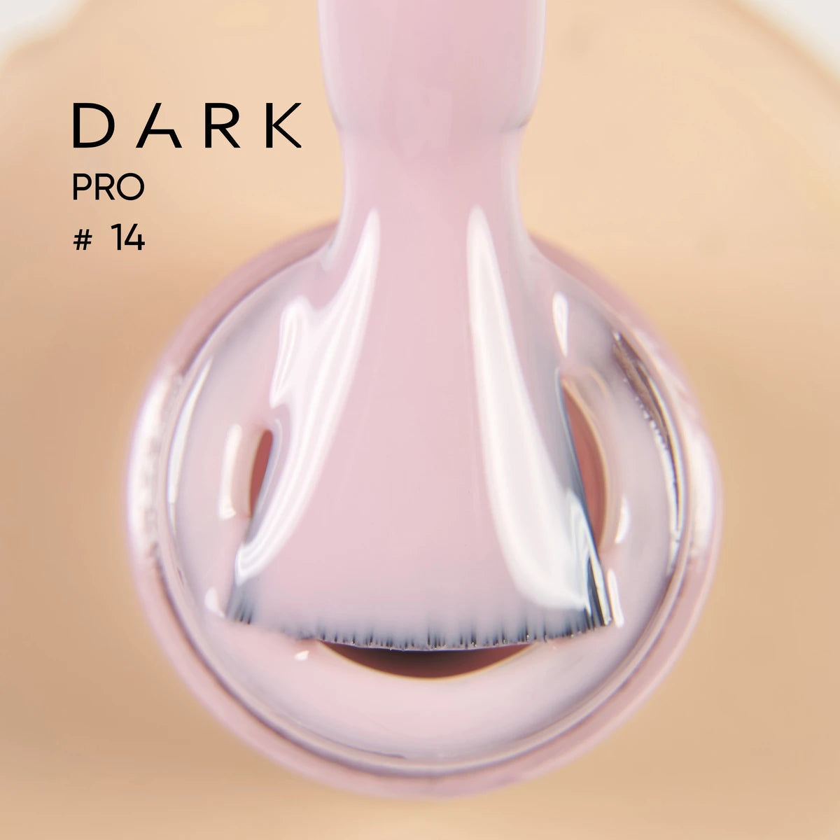 Close-up of a brush applying pale pink gel nail polish, labeled Dark Pro #14.