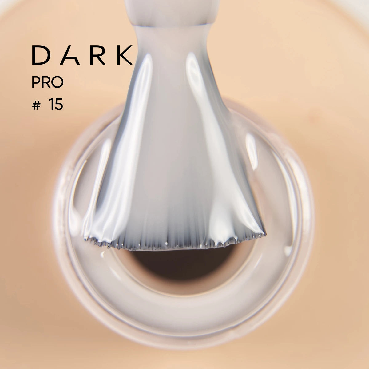 Close-up of nail polish brush with light beige UV gel, professional manicure product