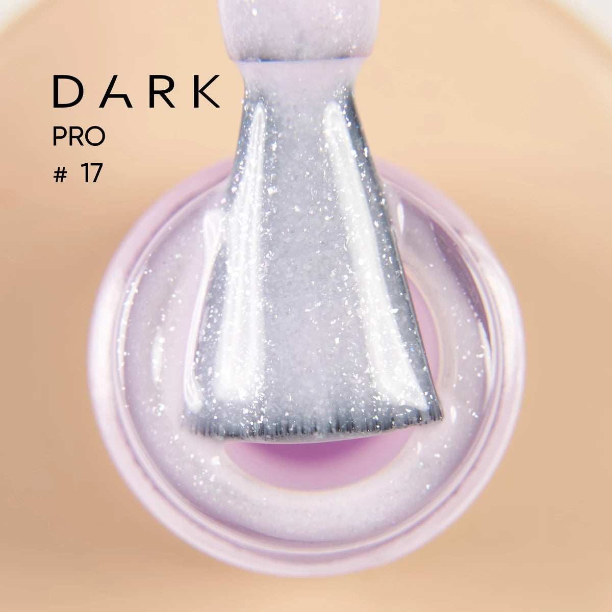 Close-up of a brush dipped in shimmery light purple gel nail polish, labeled Dark Pro #17.