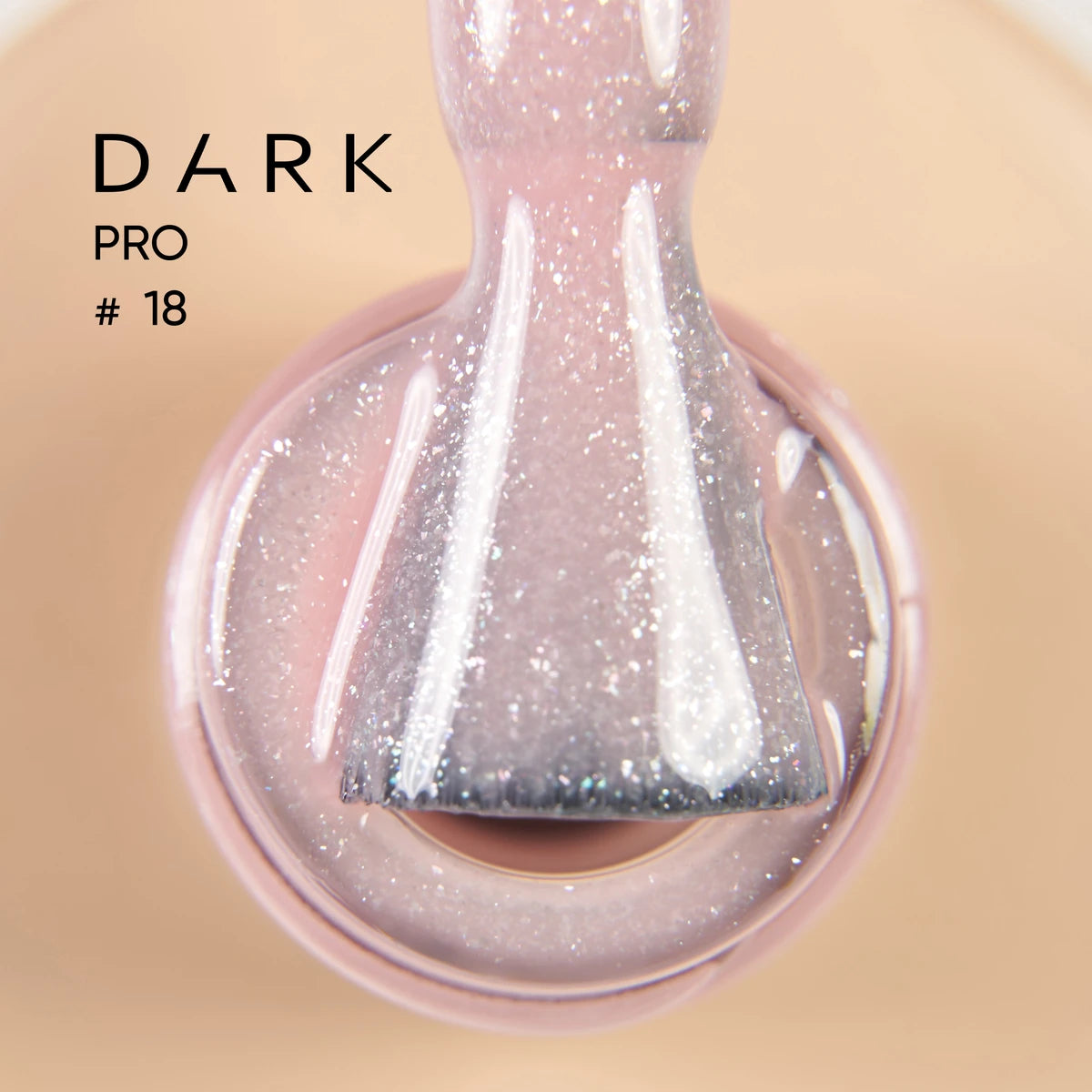 Close-up of glittery pale pink UV gel nail polish brush, labeled Dark Pro 18
