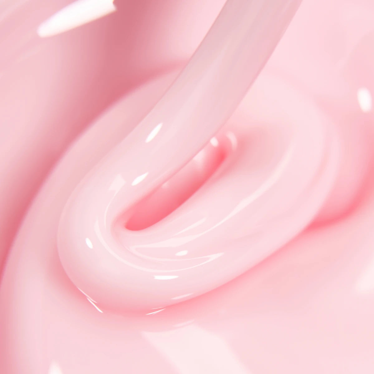 Closeup of glossy pink UV gel for nails, thick creamy texture, manicure product