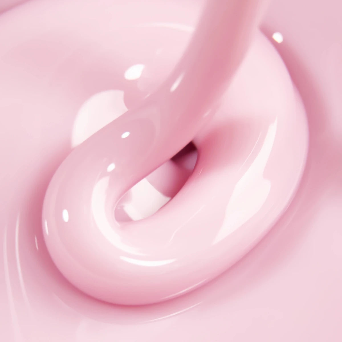 Close-up of glossy pink UV gel nail polish with smooth, creamy texture for manicures.