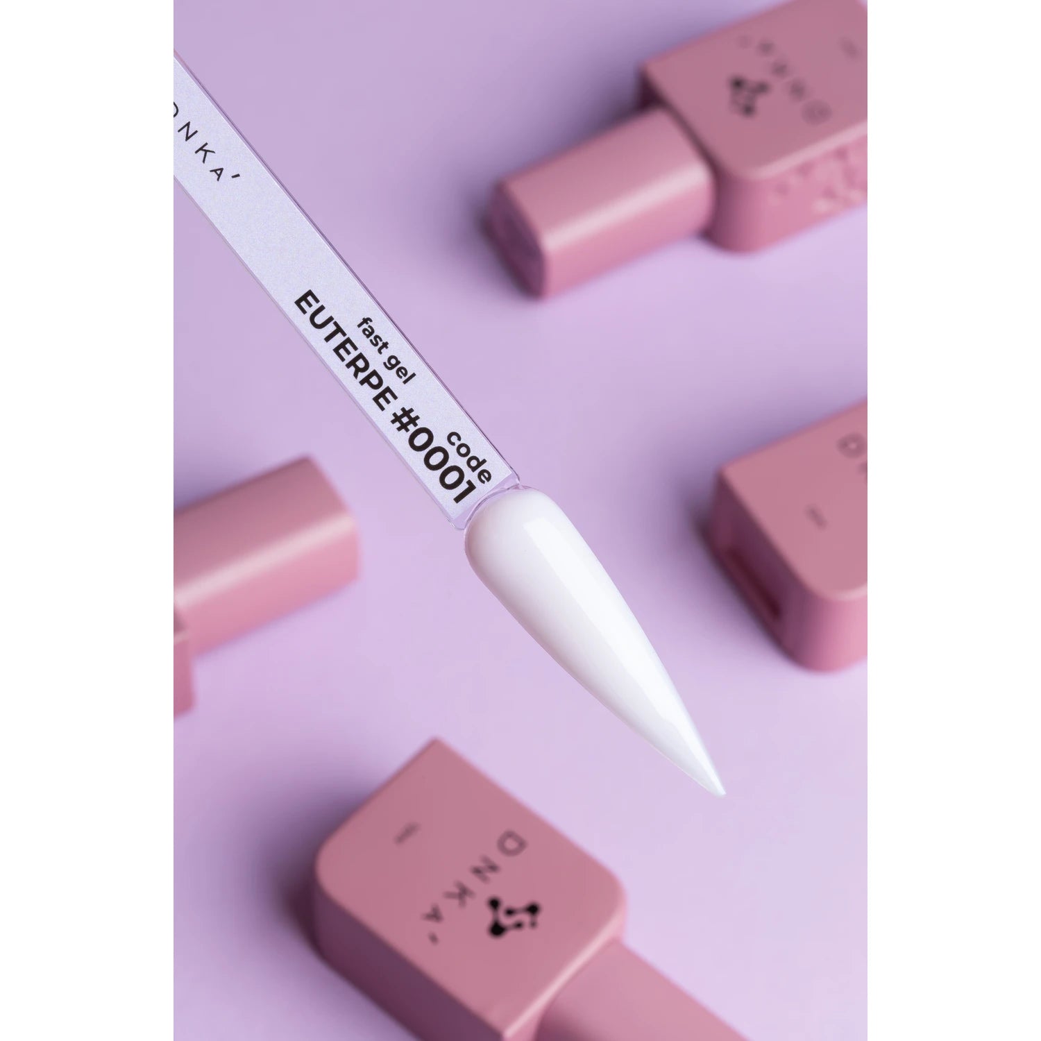 White gel nail polish sample labeled EUTERPE #0001 with pink manicure bottles on pastel background