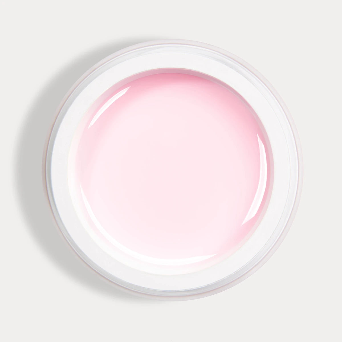 Pink UV gel for nails in an open white container, professional manicure product
