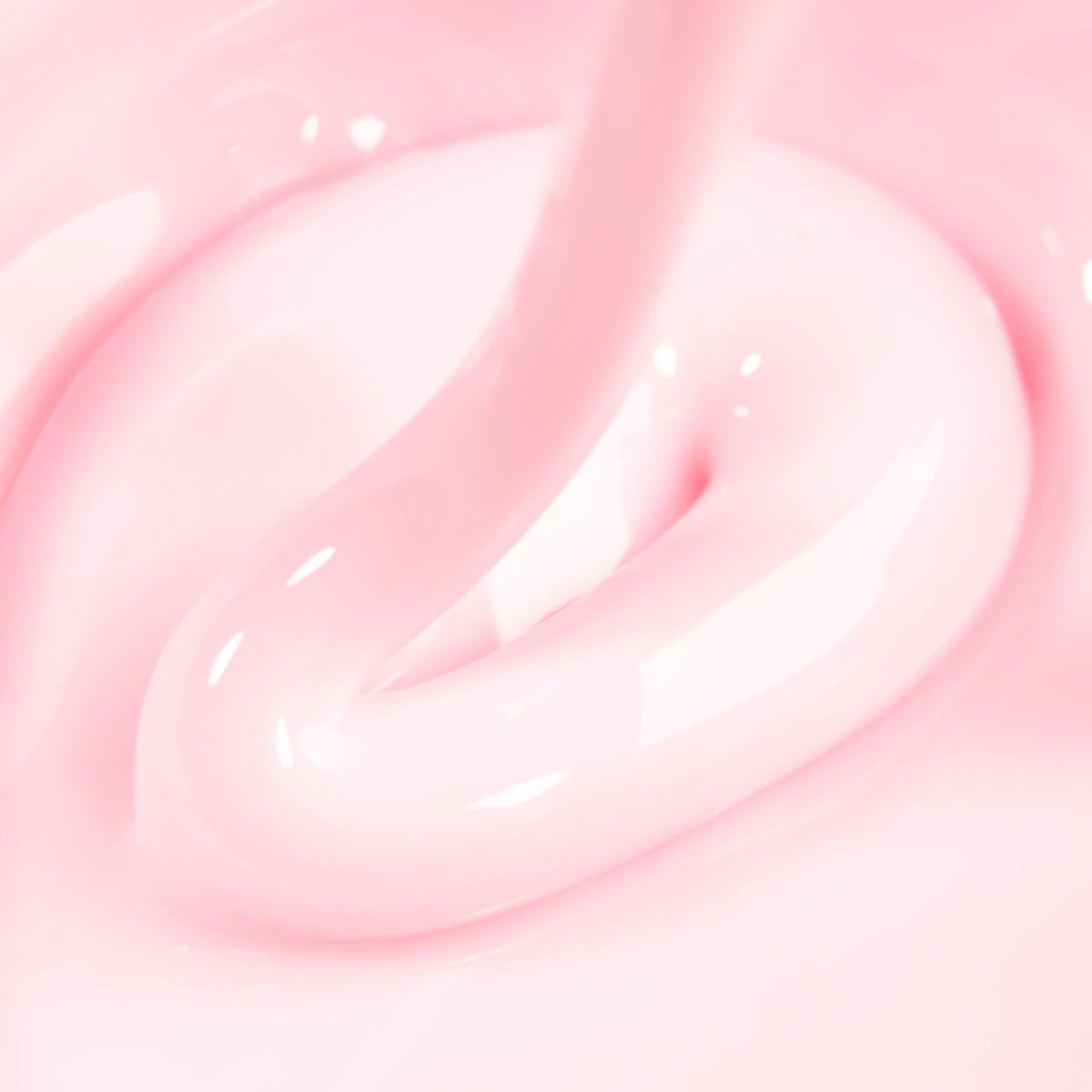 Close-up of glossy pink builder gel for nails, creamy texture, nail enhancement product
