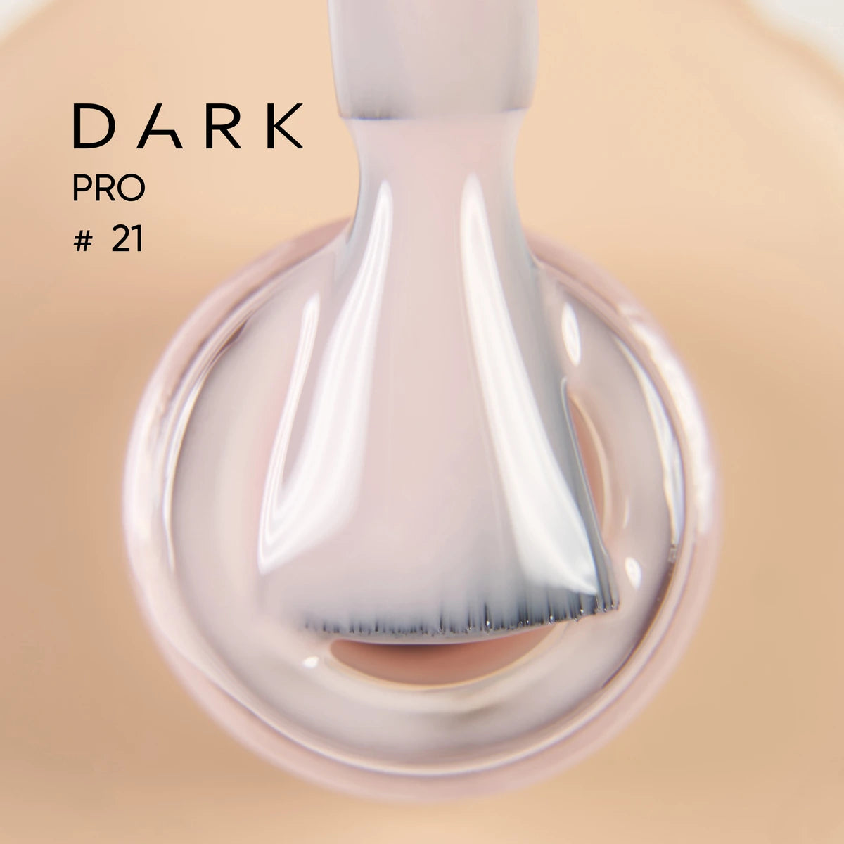 Close-up of a brush applying light nude gel nail polish, labeled Dark Pro #21.