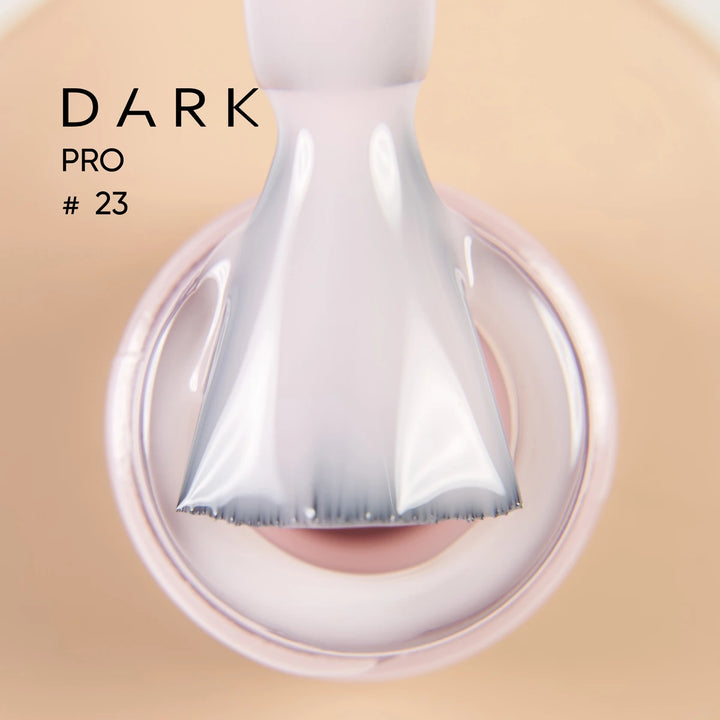 Close-up of nail polish brush applying milky pink UV gel for manicure, labeled DARK PRO 