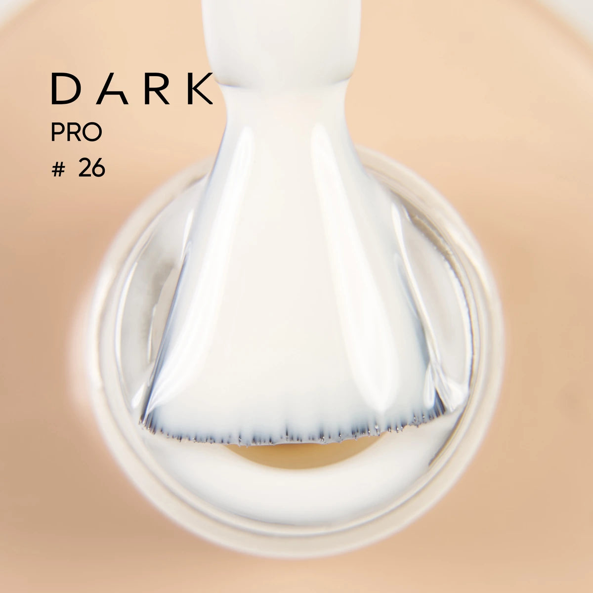 Close-up of a brush with milky white gel polish in a bottle, labeled Dark Pro #26.