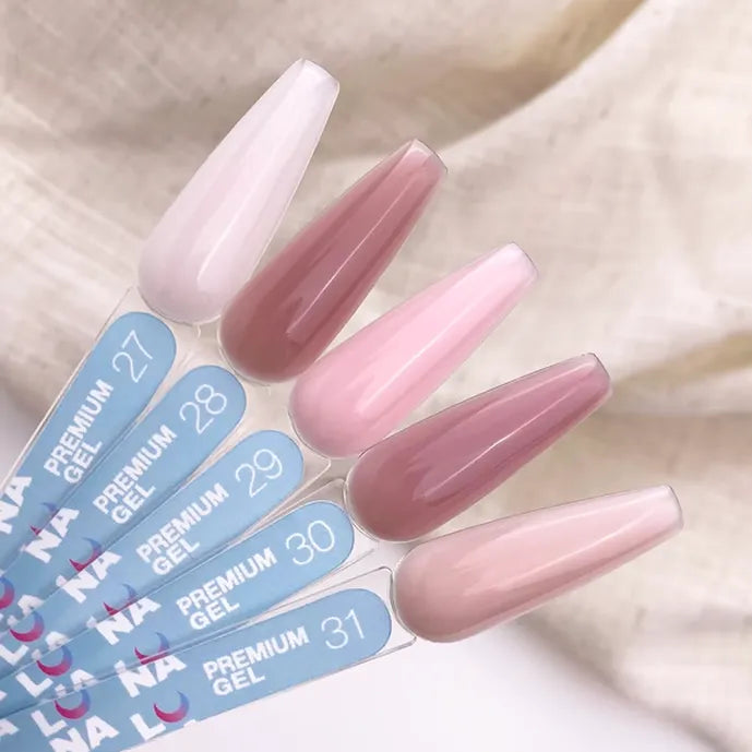 Set of long, pointed artificial nails with color options displayed on a neutral background