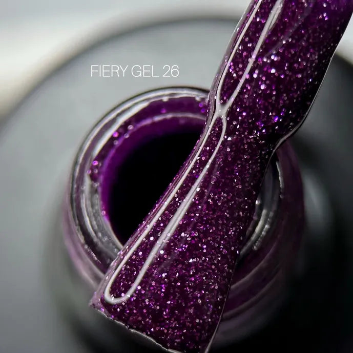 Closeup of Fiery Gel 26, a sparkly purple UV gel nail polish brush and bottle.
