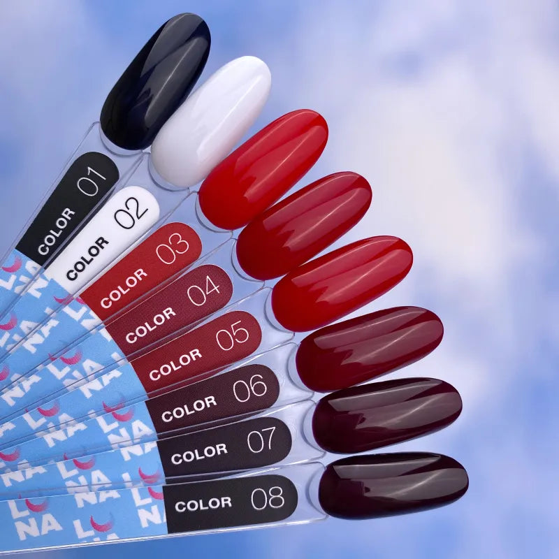 Nail polish color swatches with black, white, red, and burgundy UV gel shades against a sky background.