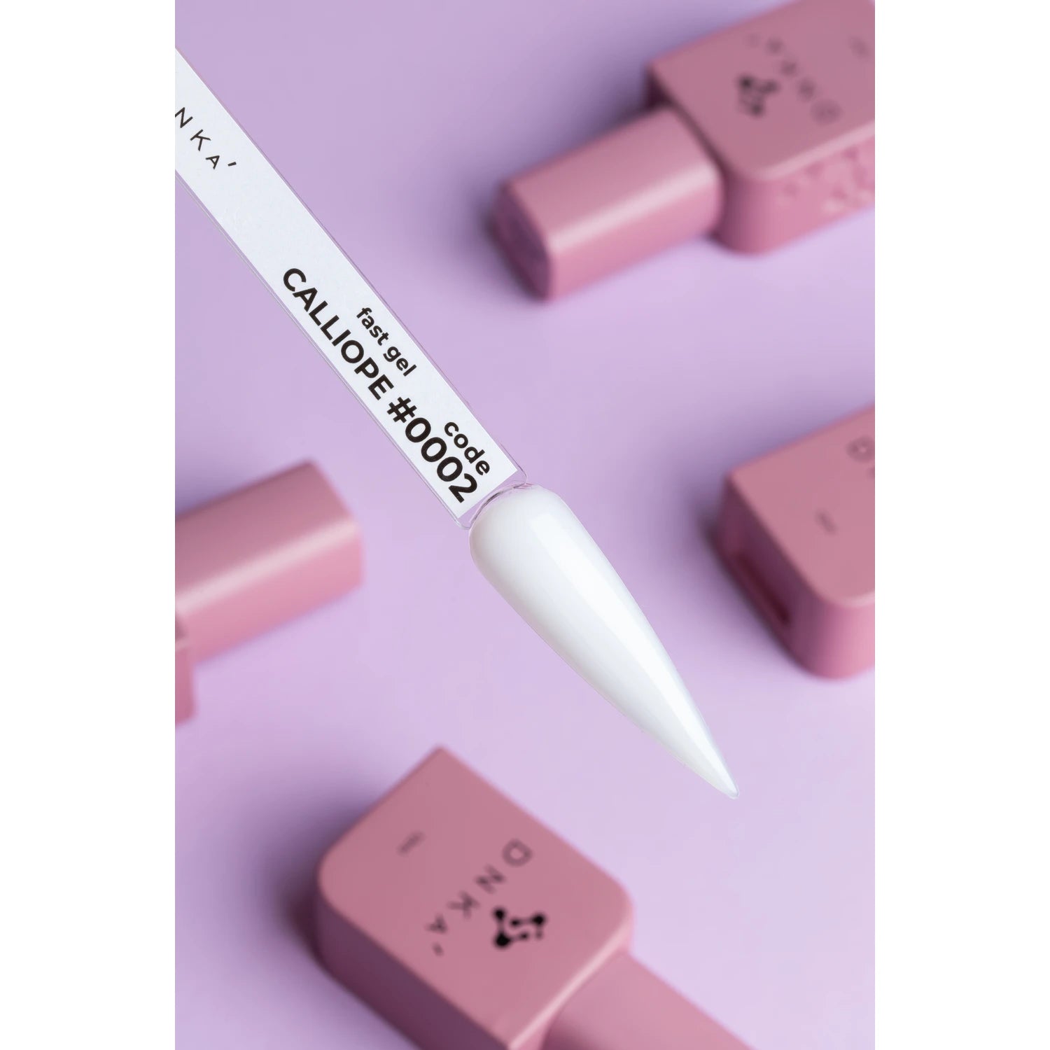 White gel nail polish swatch labeled Calliope #0002 with pink bottles on purple background