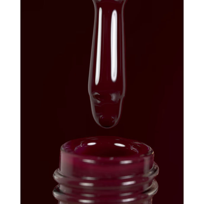 Rich burgundy gel nail polish bottle with applicator brush and glossy finish