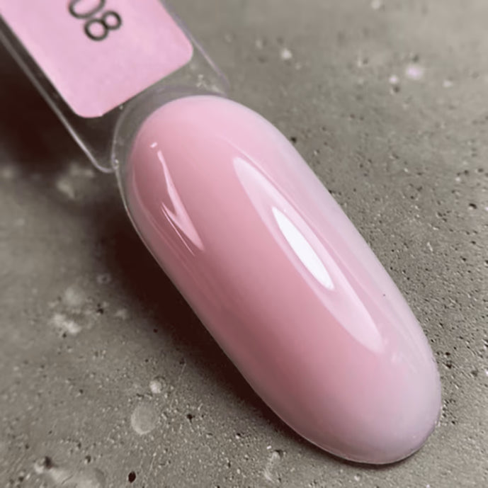 Light pink UV gel polish color sample on a nail display stick, glossy finish