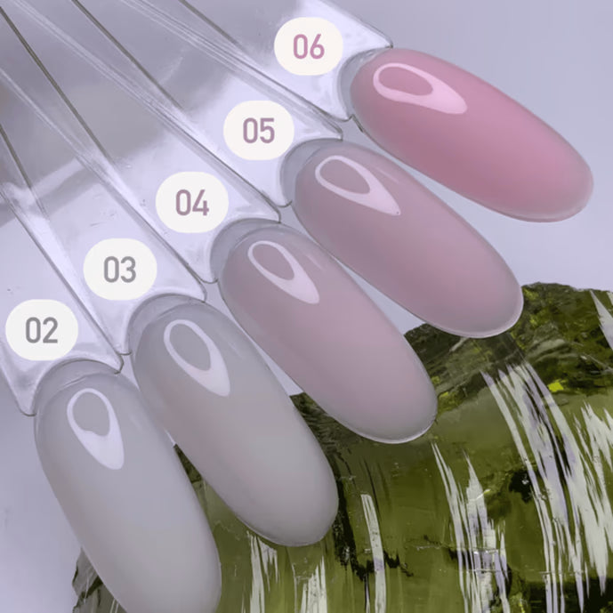 Five nail color samples ranging from light gray to soft pink, labeled 02 to 06, on swatch sticks.
