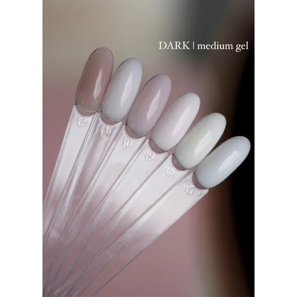 Six nail gel color swatches in neutral, nude and light shades for manicure display.