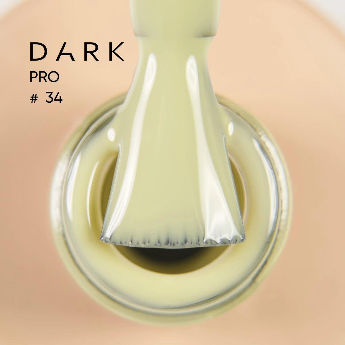 Cream gel nail polish bottle with applicator brush close-up, labeled Dark Pro #34