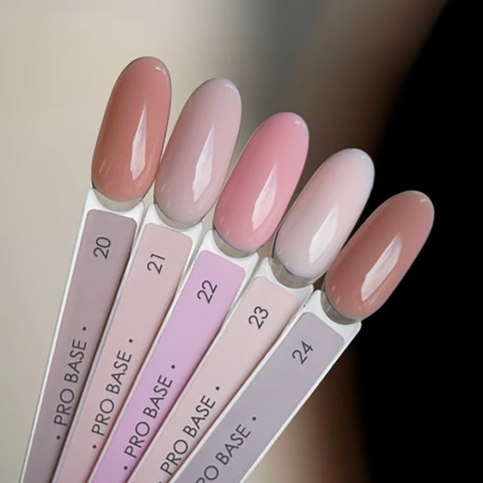 Set of five nude and pink gel nail polish color samples for manicure