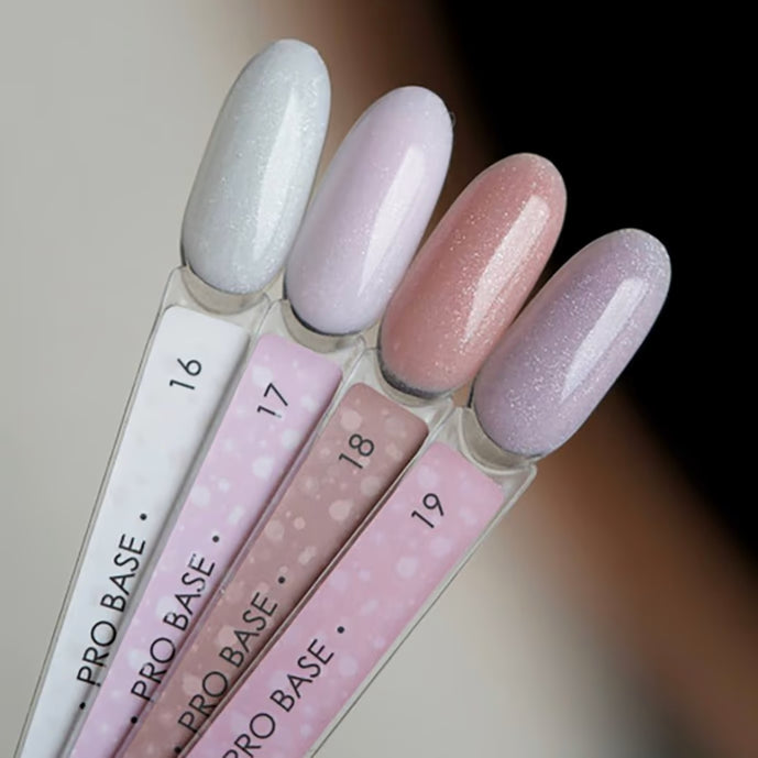Set of four pastel shimmer gel nail polish swatches in soft pink and lavender shades