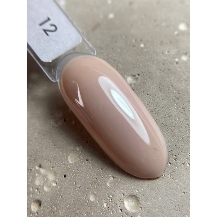 Sample swatch of nude pink gel nail polish on a display tip, glossy finish