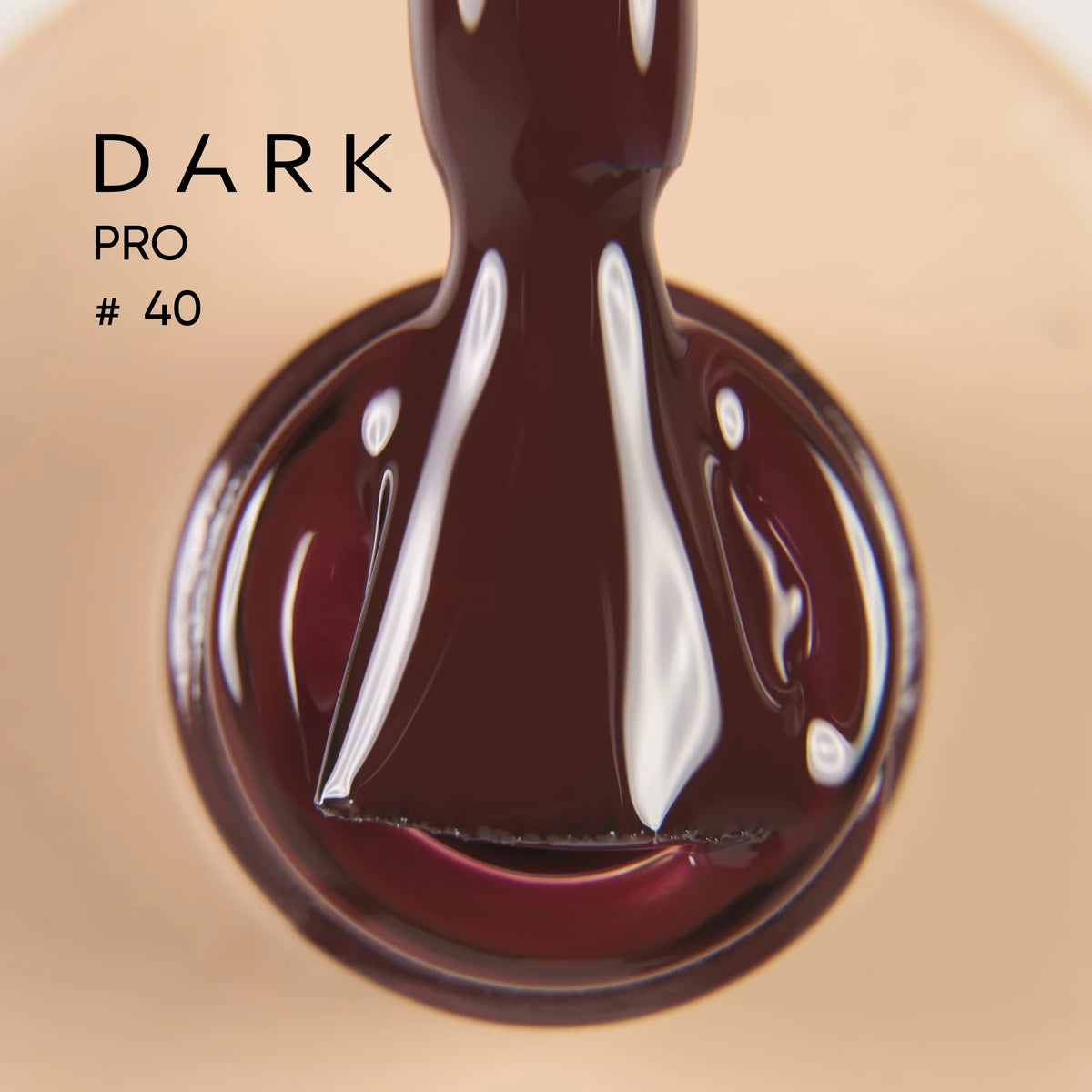 Dark brown gel nail polish brush close-up, labeled Dark Pro #40, glossy finish, manicure product