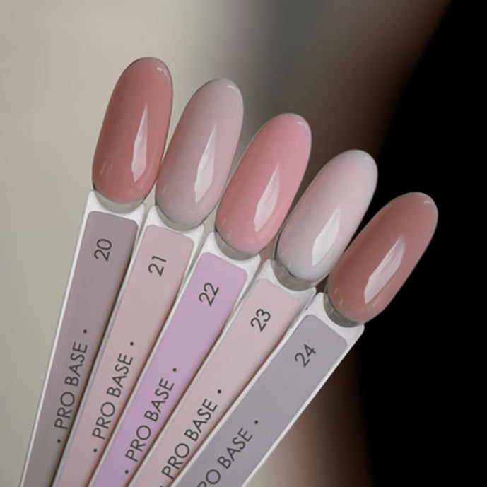 Assorted nude and pink gel nail polish swatches on sample sticks for manicure