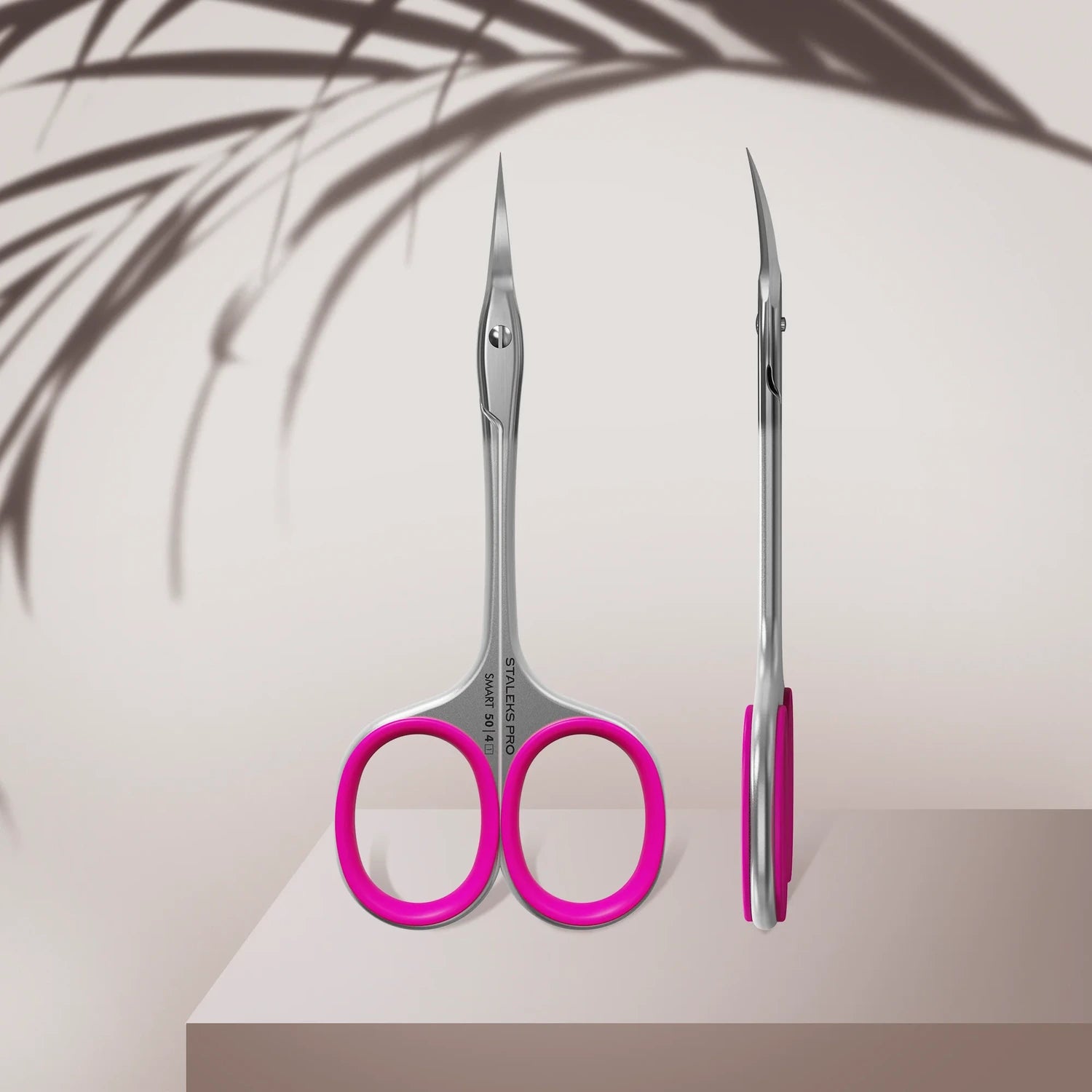 Stainless steel manicure scissors with pink handles, curved sharp blades, nail care tool